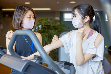 スポーツジムで指導を受ける女性（マスク）
