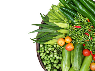 The vegetables set is comprised of variety of organic vegetables and herbs, such as: Winged beans, cucumbers, turkey berry, lemons, tomatoes and chili. Vegetable set in basket.