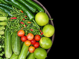 The vegetables set is comprised of variety of organic vegetables and herbs, such as: Winged beans, cucumbers, turkey berry, lemons, tomatoes and chili. Vegetable set in basket.