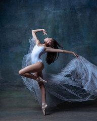 Fototapeta premium One young and flexible ballet dancer, ballerina dancing isolated on dark vintage studio background. Art, motion, action concept.