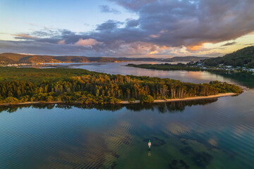 Aerial sunrise over the bay with clouds and reflections
