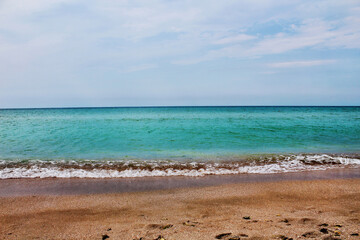 Fototapeta na wymiar Blue sea wave on a pebble beach.