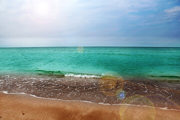 Blue sea wave on a pebble beach.