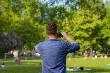 a man takes pictures of people in the park
