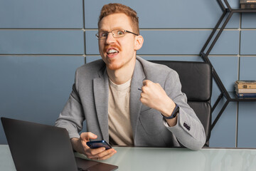 A man clenched his fist with a greedy expression on his face
