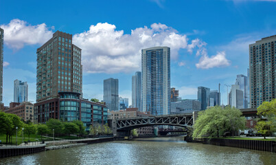 Fototapeta na wymiar Chicago cityscape, waterfront skyscrapers on the river canal, spring day blue sky background. Illinois, USA
