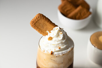 Close up of coffee with whipped cream and cookies .New dalgona coffee