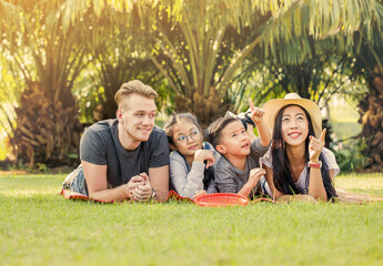 Happy family lying and relaxing in the park