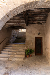 stone street with some stairs and an arch in the medieval village of Guimerá in northern Spain