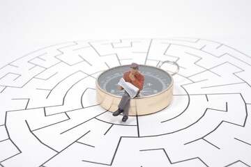 a Businessman in the labyrinth or maze figuring out the way out. Business concep