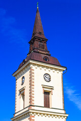 Fototapeta na wymiar Church tower with clock against a blue sky