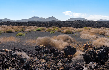 Volcanic landscape full of malpais or lava in Tierra de Voclcanes, natural park of Lanzarote,...