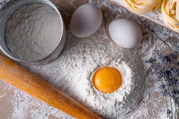 Homemade fettuccine pasta folded in the shape of a nest. Home cooking with ingredients for homemade traditional Italian fettuccine pasta.