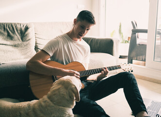 Man plays guitar with his pet.