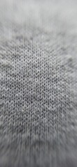 Fototapeta na wymiar Close-up fabric texture. Gray jersey close up. Interlacing of threads. Sewing and knitting. Preparing for handicraft work. 