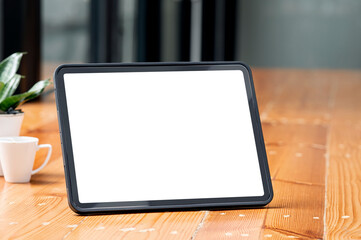 Mockup blank white screen tablet on wooden table, closeup view.