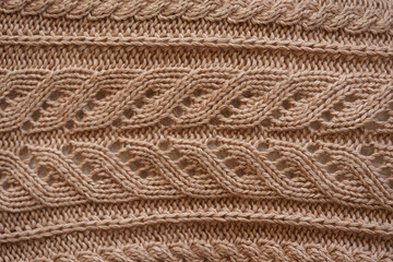 brown knitted pattern. texture of a knitted woolen thing. warm color.
