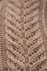 brown knitted pattern. texture of a knitted woolen thing. warm color.