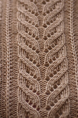 brown knitted pattern. texture of a knitted woolen thing. warm color.