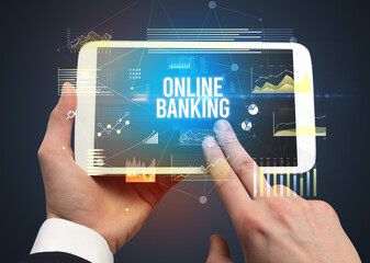 Close-up of hands holding tablet with business inscription