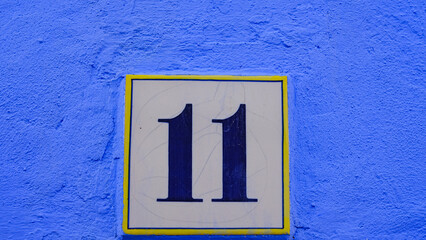ceramic house number table. number: 11 on a blue background