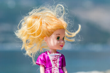 Fototapeta premium Plastic children's doll dressed in a pink dress. 