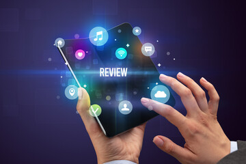 Businessman holding a foldable smartphone