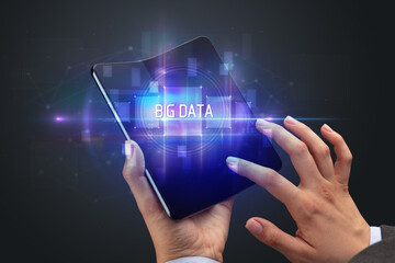 Businessman holding a foldable smartphone