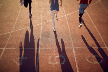 group of runners racing on running track.