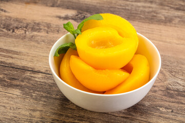 Sweet ripe canned peaches with mint