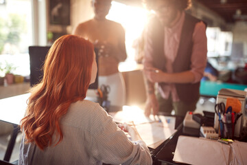 Group of young colleagues looking project documents at office. Employees, office, work