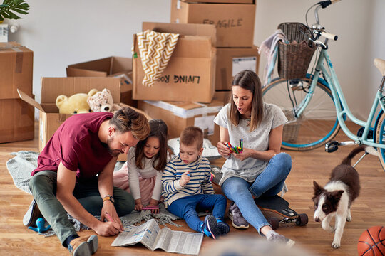 Caucasian Family With Two Childern And A Dog Moving Out