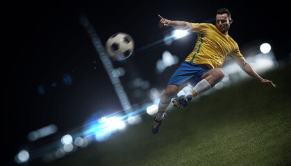 A professional soccer player demonstrates complex moves in the soccer arena wearing a yellow jersey and blue shorts. - 464663241