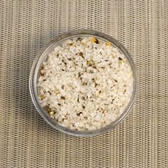 Spices, white, black and red peppers, sea salt sprinkled on grey background, close-up