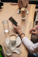 Relaxing with the coffee while looking at the phone