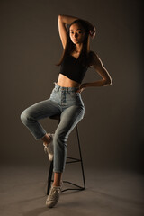 Posing on the high chair in studio