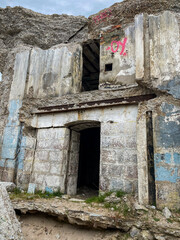 Fototapeta premium Old concrete building. collapsed building by the sea