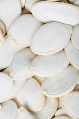 Pumpkin seeds in a shell as a textural background.