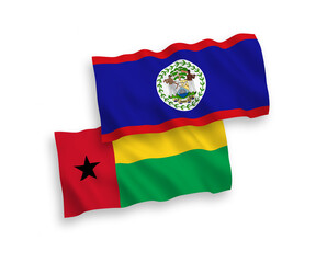 Fototapeta premium National vector fabric wave flags of Republic of Guinea Bissau and Belize isolated on white background. 1 to 2 proportion.