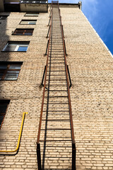 bottom view of fire escape to roof of brick house