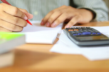 Hand businessman doing finances and calculate about cost.
