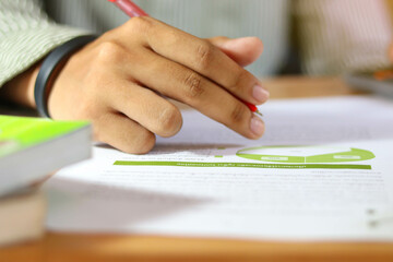 Close up Hand businessman analyzing finances and calculate about cost.