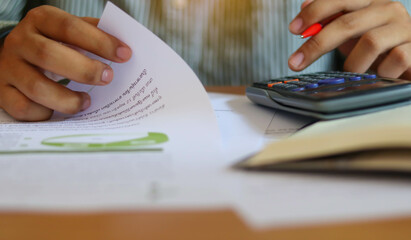Hand businessman doing finances and calculate about cost.