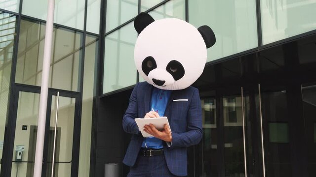 Storytelling video of a businessman wearing a giant panda mask. 