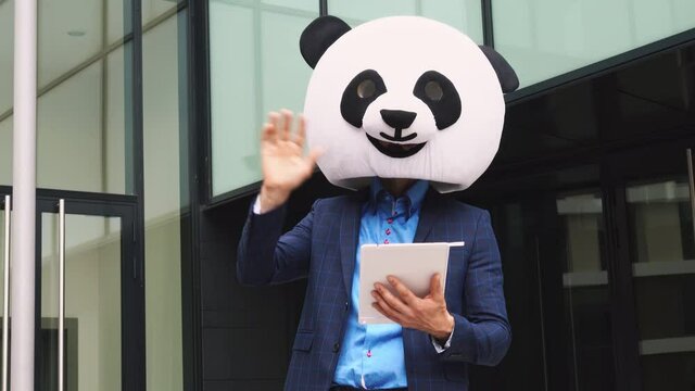 Storytelling video of a businessman wearing a giant panda mask. 