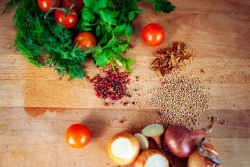 Spice and pepper with vegetables on wooden cutting board, selective focus