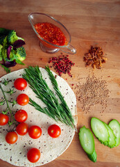 Vegetable ingredients for cooking tasty vegetarian Italian pizza, on wooden cutting board