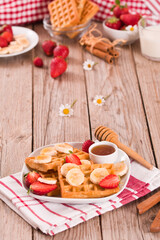 Waffles with strawberries, bananas and honey.
