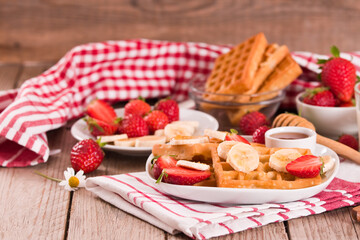 Waffles with strawberries, bananas and honey.