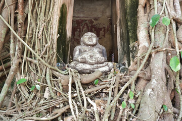 Front view of Buddha statue sitting on the temple's window